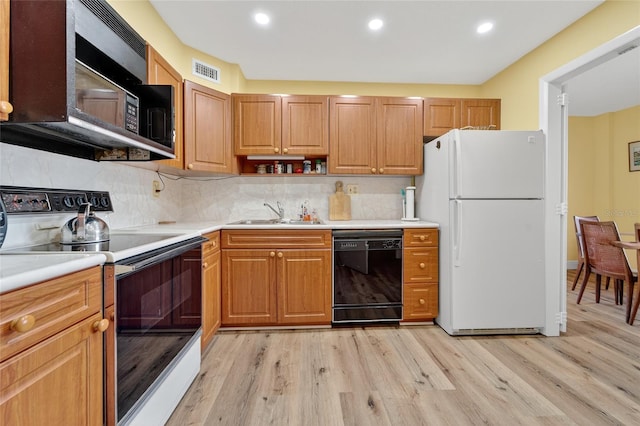 10777 W Sample Rd Unit 1212, Coral Springs, FL 33065 - kitchen featuring black appliances, light countertops, light wood finished floors, and recessed lighting