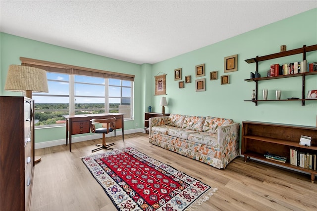 10777 W Sample Rd Unit 1212, Coral Springs, FL 33065 - living area with wood finished floors and a textured ceiling