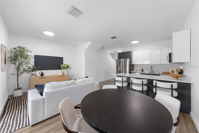 1607 NW 29th Rd Unit 2, Gainesville, FL 32605 - dining area featuring light wood-type flooring and recessed lighting
