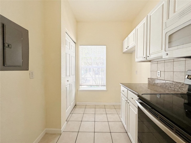 4877 NW 42nd Rd Unit 106, Gainesville, FL 32606 - kitchen featuring range with electric stovetop, white microwave, electric panel, and white cabinetry