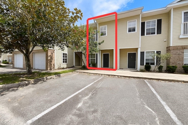 4877 NW 42nd Rd Unit 106, Gainesville, FL 32606 - view of front of home with uncovered parking and brick siding