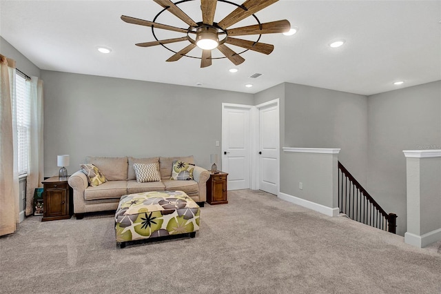 carpeted living room with baseboards, a ceiling fan, visible vents, and recessed lighting