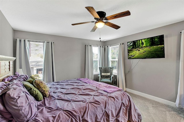 carpeted bedroom with baseboards and a ceiling fan