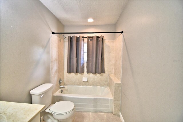 full bathroom with vanity, toilet, a textured ceiling, tile patterned floors, and tub / shower combination