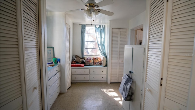 bedroom featuring ceiling fan and two closets