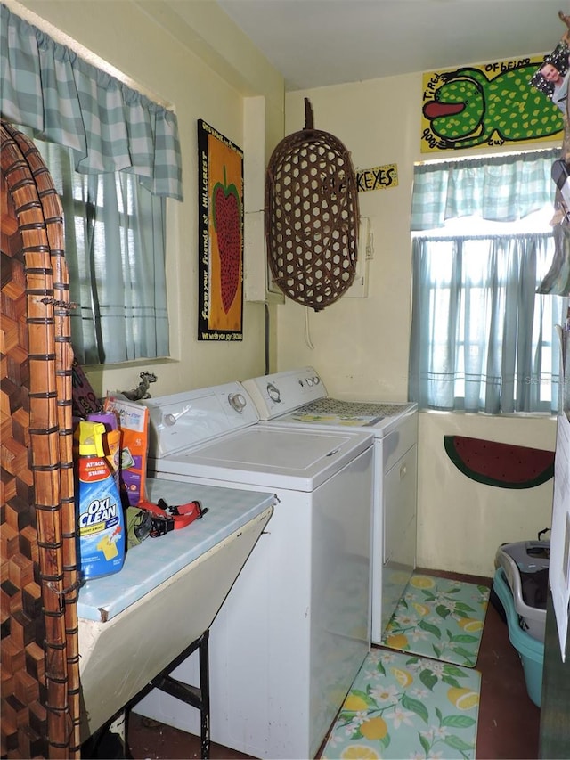 clothes washing area with washer and dryer