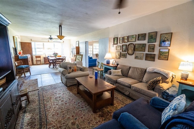 living room with ceiling fan and tile patterned floors