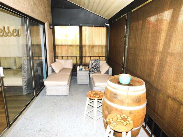 sunroom / solarium featuring lofted ceiling