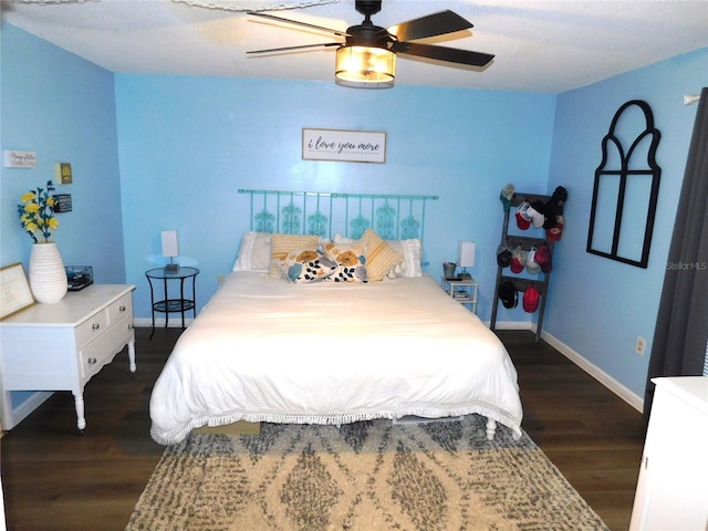 bedroom with dark hardwood / wood-style floors and ceiling fan