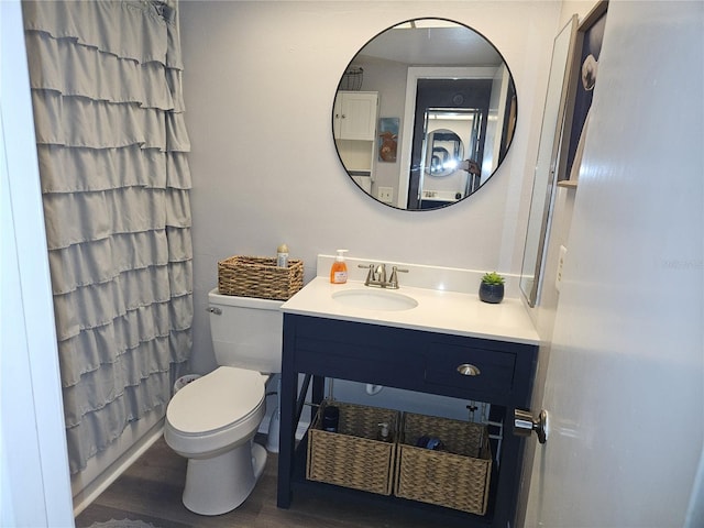 bathroom with vanity, wood-type flooring, and toilet