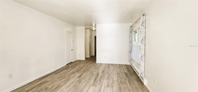 unfurnished room with light hardwood / wood-style flooring