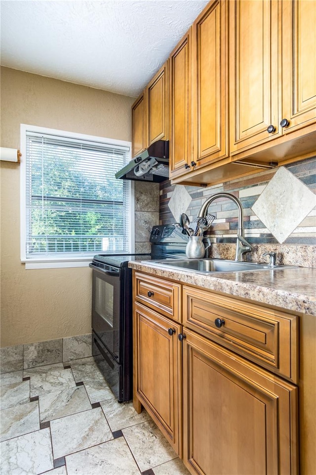 kitchen with tasteful backsplash, sink, and electric range