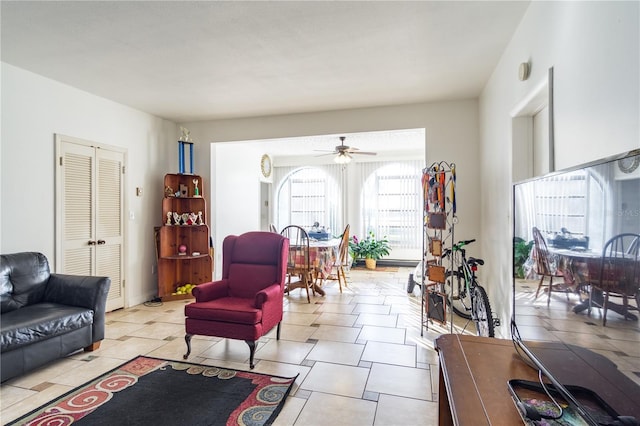 living room featuring light tile patterned flooring and ceiling fan