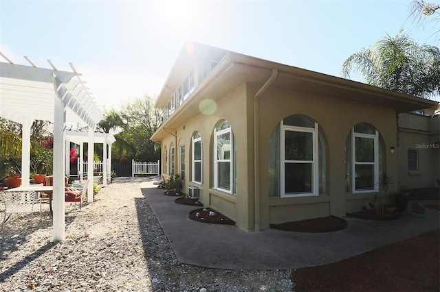 view of property exterior featuring a pergola