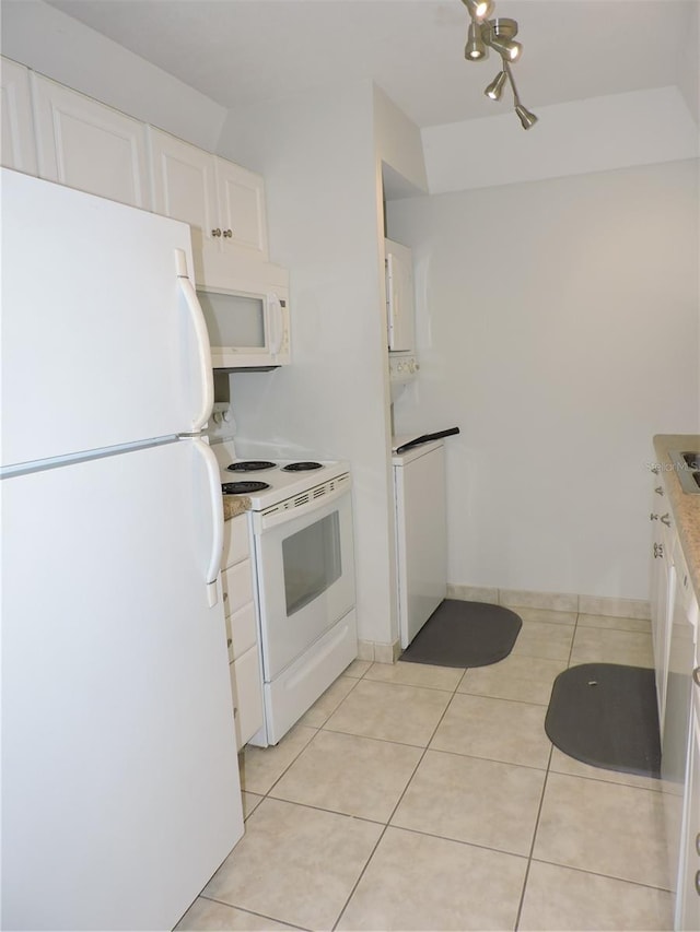 kitchen with white cabinets, white appliances, and light tile floors