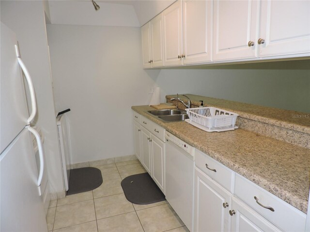 kitchen featuring white cabinetry, light stone countertops, white appliances, sink, and light tile floors