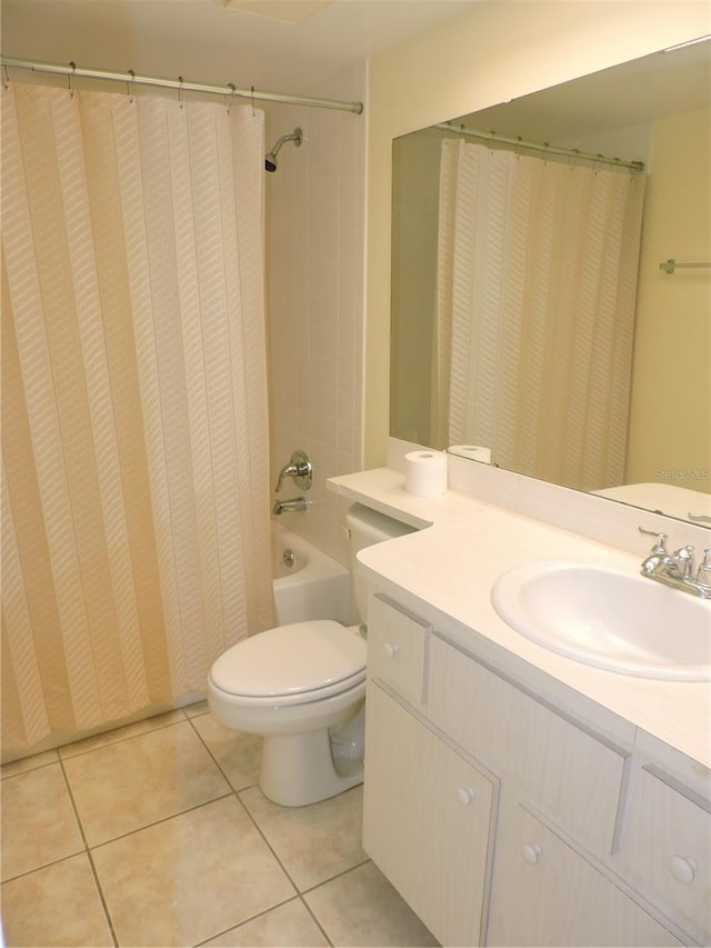 full bathroom featuring vanity with extensive cabinet space, toilet, tile floors, and shower / tub combo