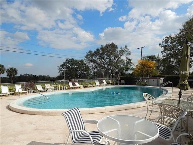 view of swimming pool with a patio