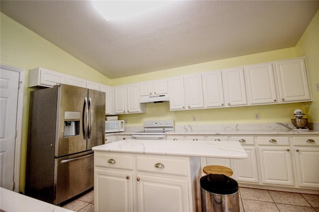 kitchen with a center island, lofted ceiling, white appliances, white cabinets, and light tile patterned floors