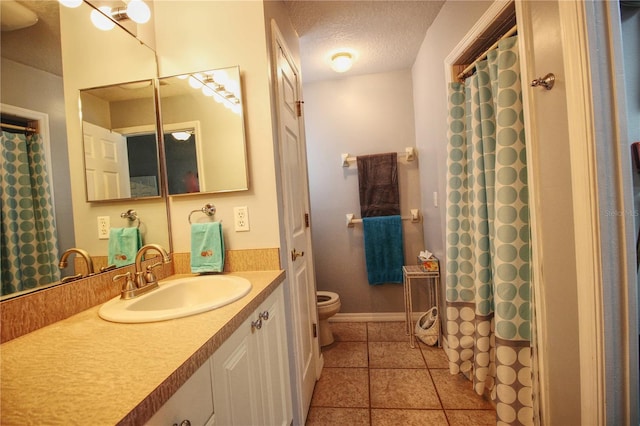 bathroom featuring vanity, tile patterned floors, toilet, a textured ceiling, and curtained shower