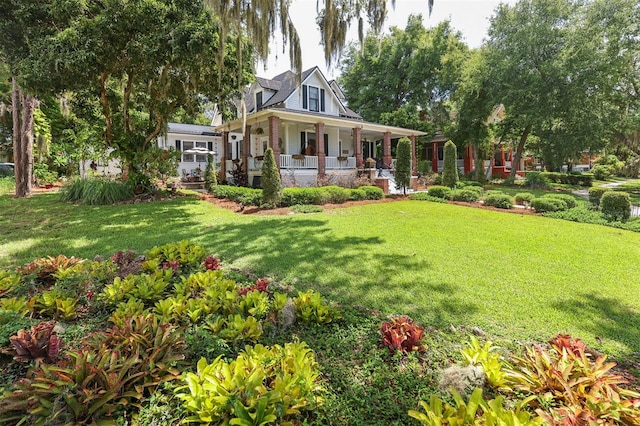 view of front of house with a porch and a front lawn