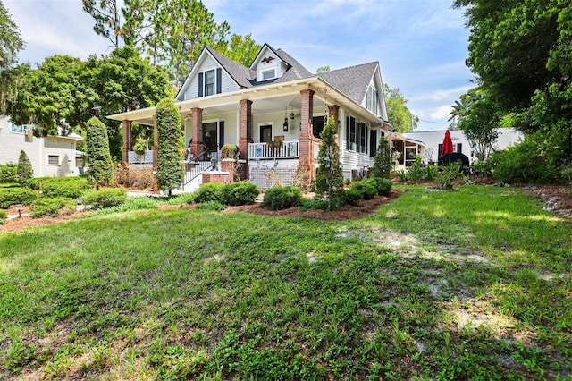 view of front of property featuring covered porch and a front yard