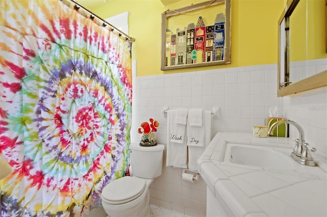 bathroom featuring toilet, tile walls, and sink