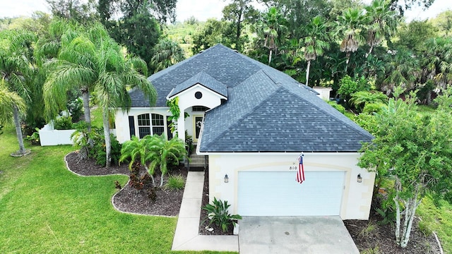 view of front of house featuring a garage and a front yard