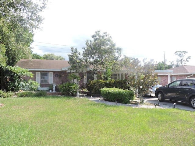 view of front of home with a front yard and a garage