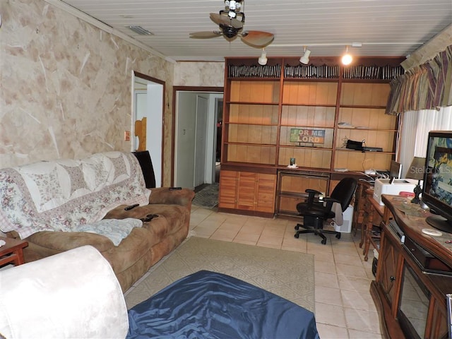 living room with crown molding, light tile patterned floors, and ceiling fan