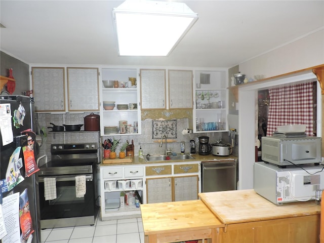 kitchen featuring light tile patterned floors, appliances with stainless steel finishes, sink, and backsplash