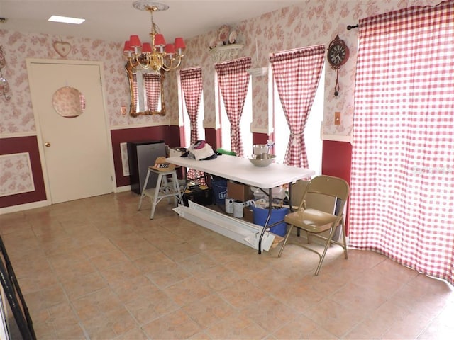 tiled dining space with a notable chandelier