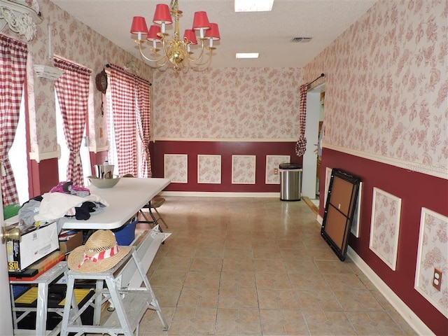 tiled dining area with an inviting chandelier