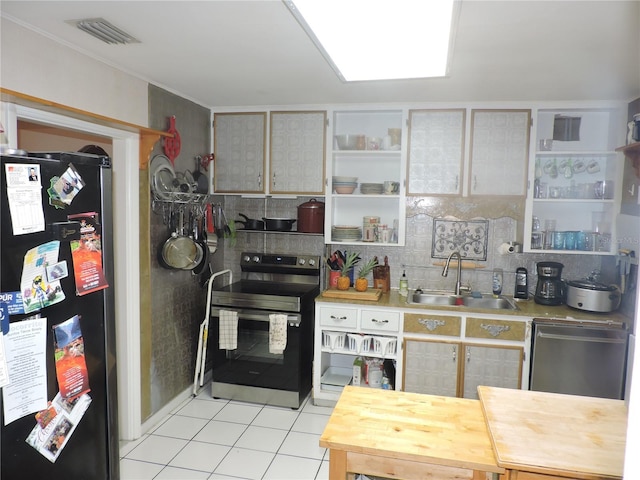 kitchen featuring light tile patterned flooring, appliances with stainless steel finishes, sink, and backsplash