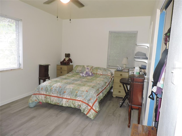 bedroom with ceiling fan and light hardwood / wood-style flooring