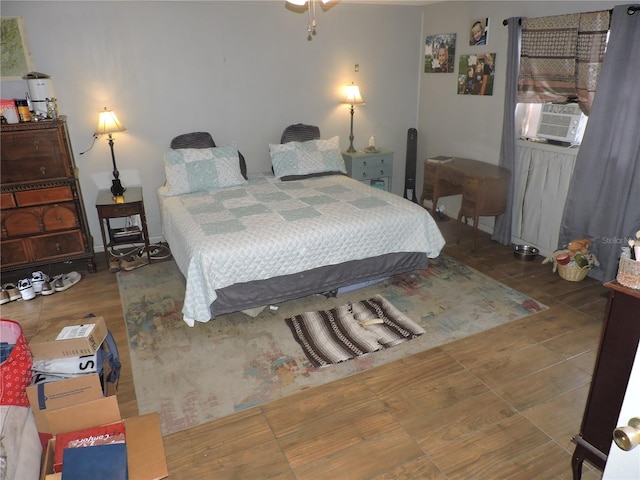 bedroom with wood-type flooring and cooling unit