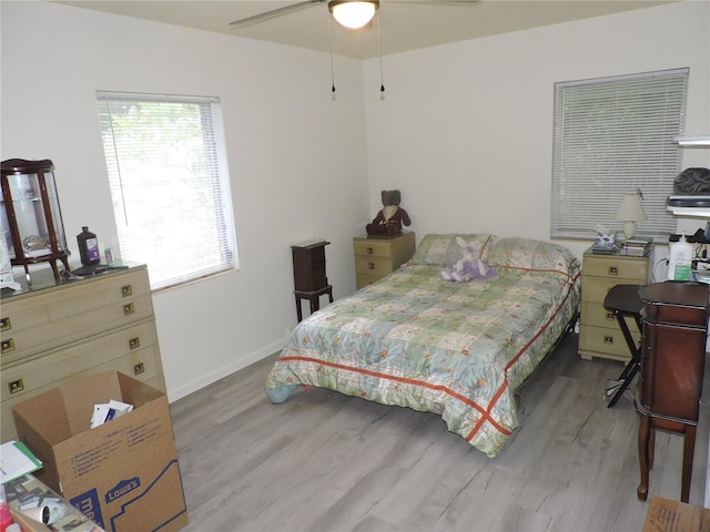 bedroom with light hardwood / wood-style floors and ceiling fan