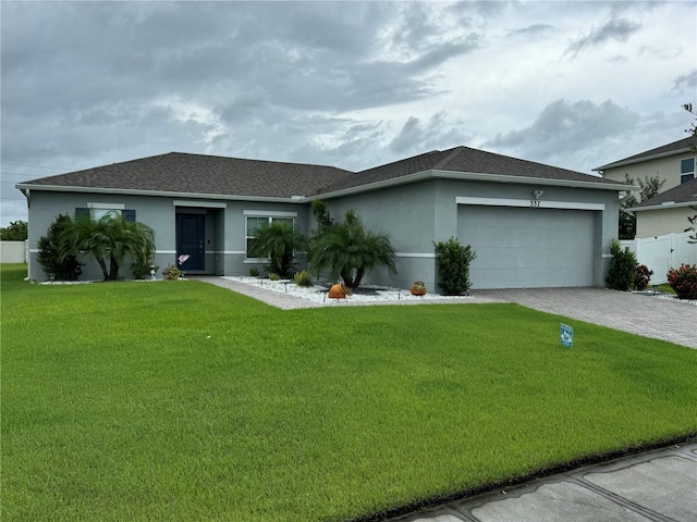 ranch-style home with a garage and a front lawn