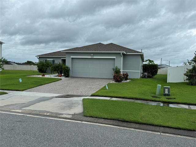 view of front facade featuring a garage and a front lawn