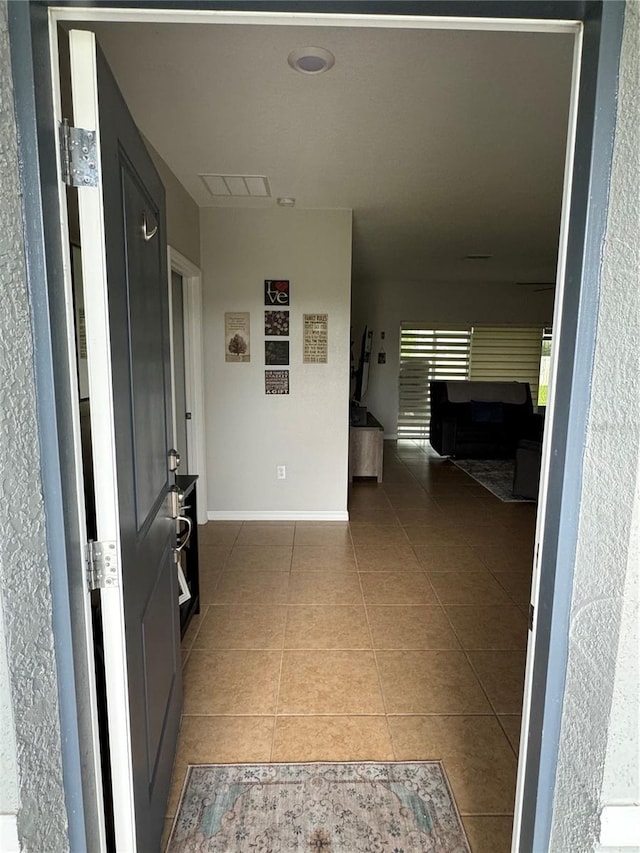 hall with tile patterned flooring