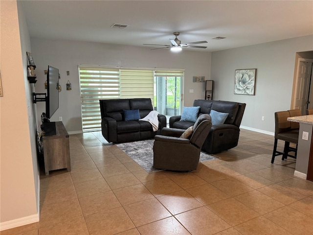 living room with ceiling fan and light tile patterned floors