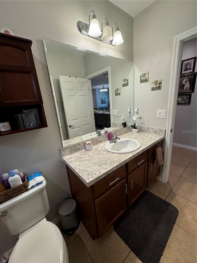 bathroom featuring tile patterned floors, vanity, and toilet