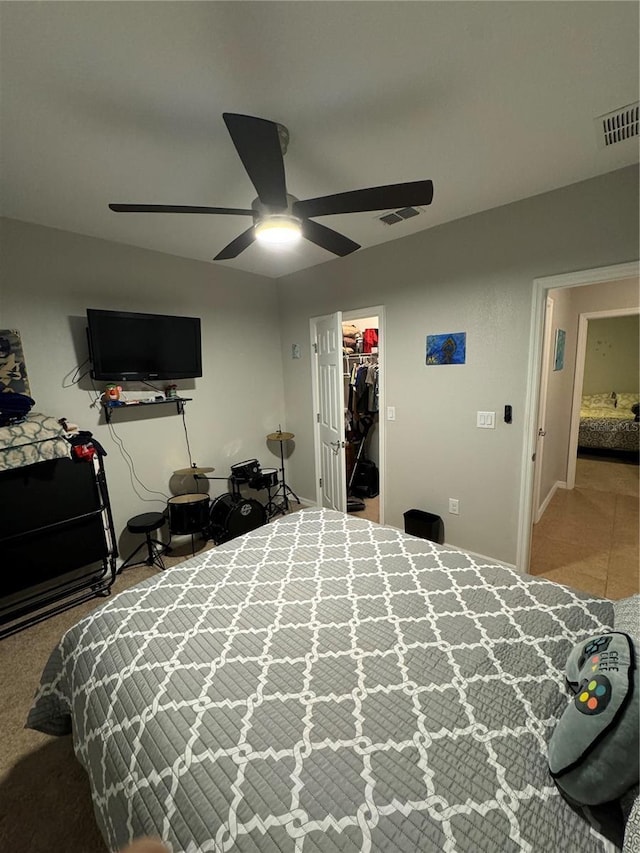 bedroom featuring a closet, a spacious closet, and ceiling fan