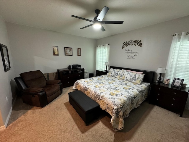 bedroom featuring light carpet and ceiling fan