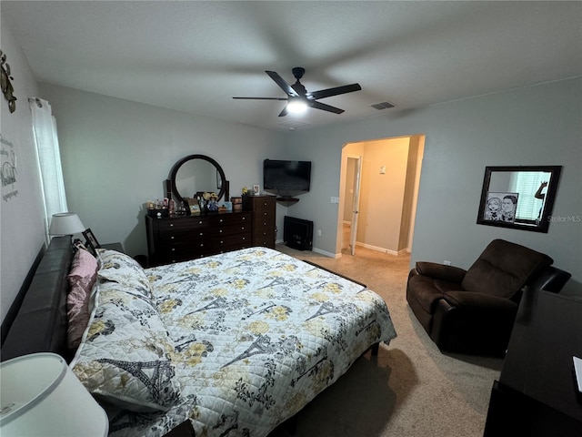 bedroom with ceiling fan and light carpet