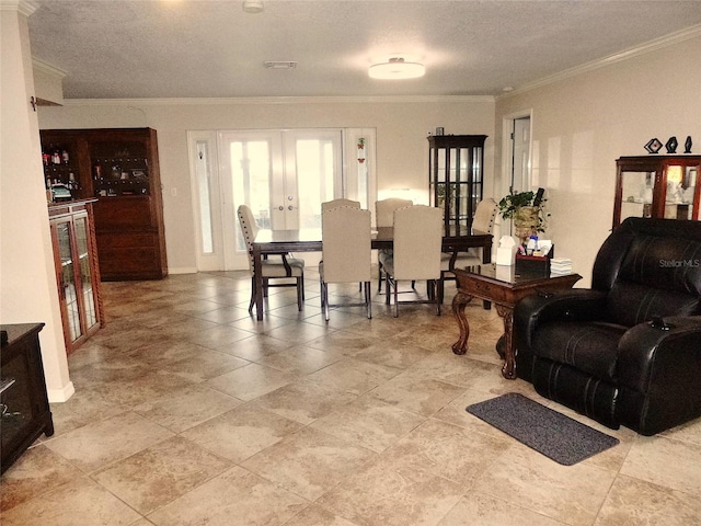 tiled living room with a textured ceiling, french doors, and crown molding