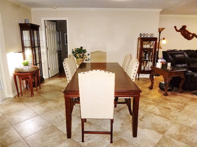 dining area with light tile patterned flooring and crown molding