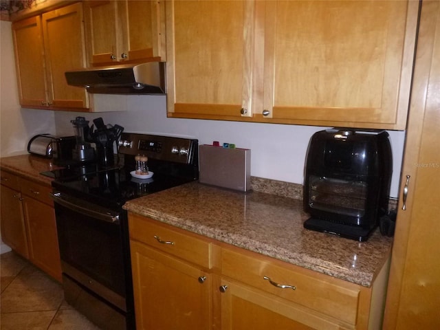 kitchen with light stone countertops, electric stove, light tile patterned floors, and wall chimney range hood