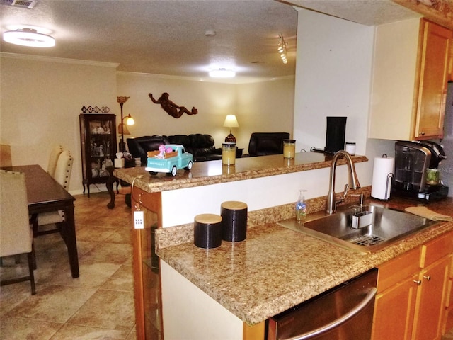 kitchen featuring a textured ceiling, crown molding, dishwasher, light tile patterned floors, and sink