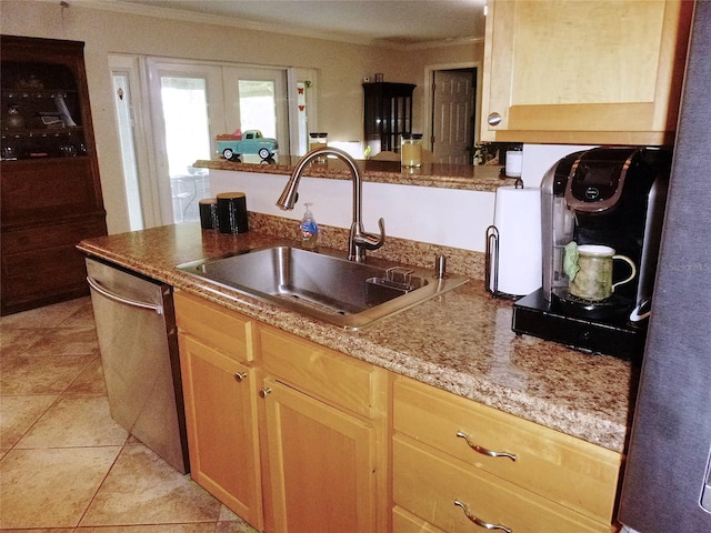 kitchen featuring light brown cabinets, light tile patterned floors, sink, and dishwasher